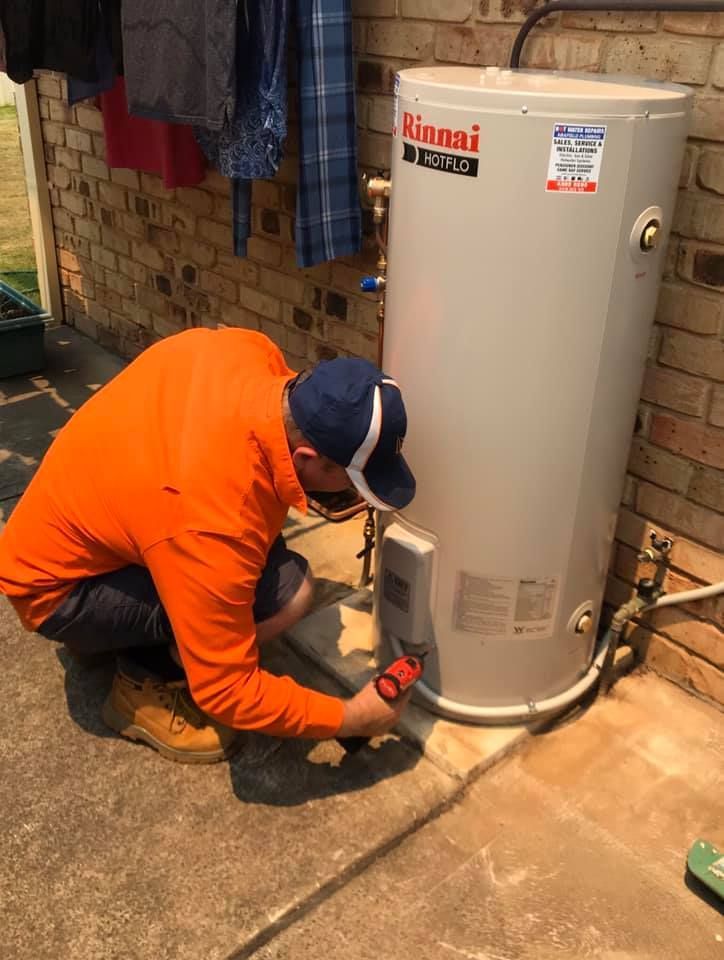 A Person is Holding a Thermometer in Front of a Electrical Panel — Gunter Electrical In Woy Woy, NSW
