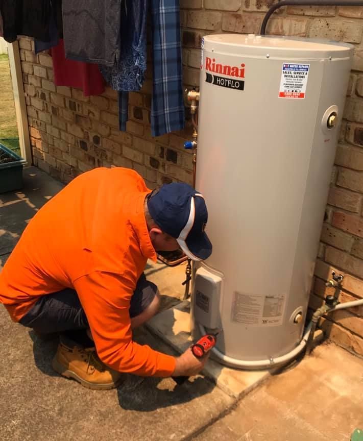 A Man is Working on a Power Line in a Level 2 Bucket — Gunter Electrical In Kariong, NSW