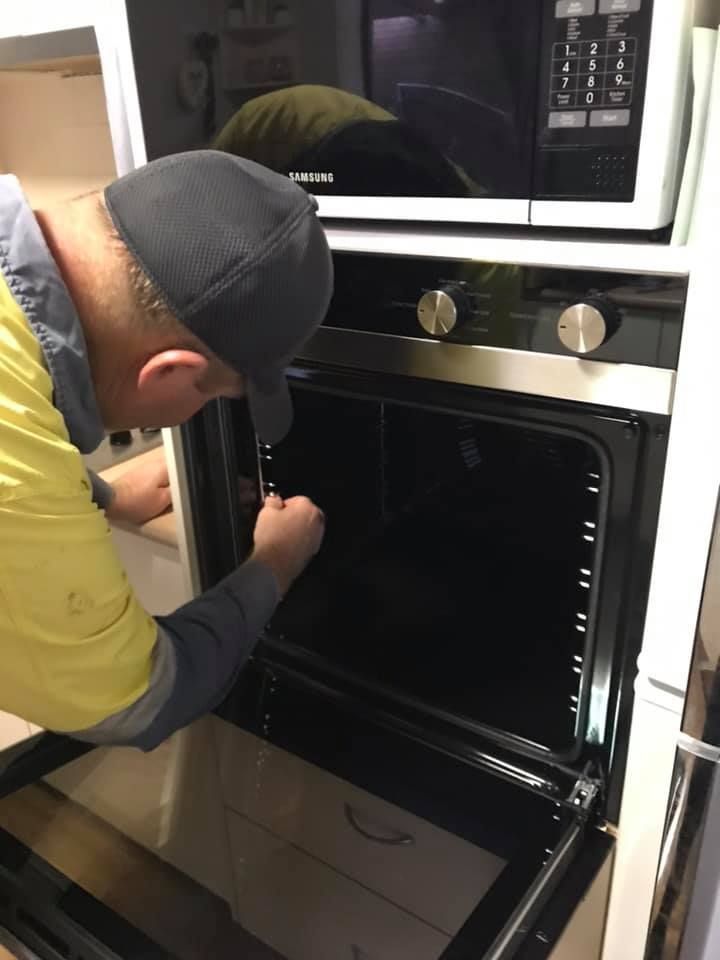 A Person is Using a Multimeter to Test a Circuit Board — Gunter Electrical In Kariong, NSW