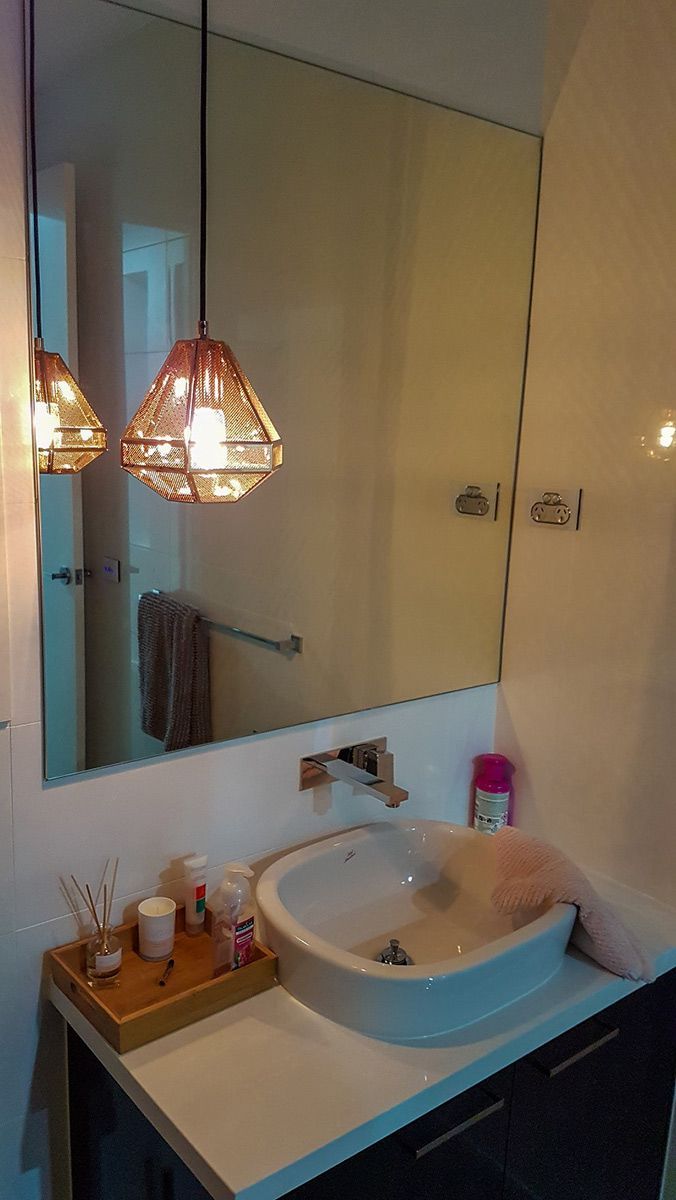 A Bathroom With a Sink and a Mirror — Gunter Electrical In Kariong, NSW