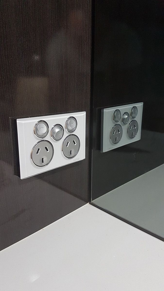 A Close Up of a Electrical Outlet on a Wall Next to a Mirror — Gunter Electrical In Kariong, NSW