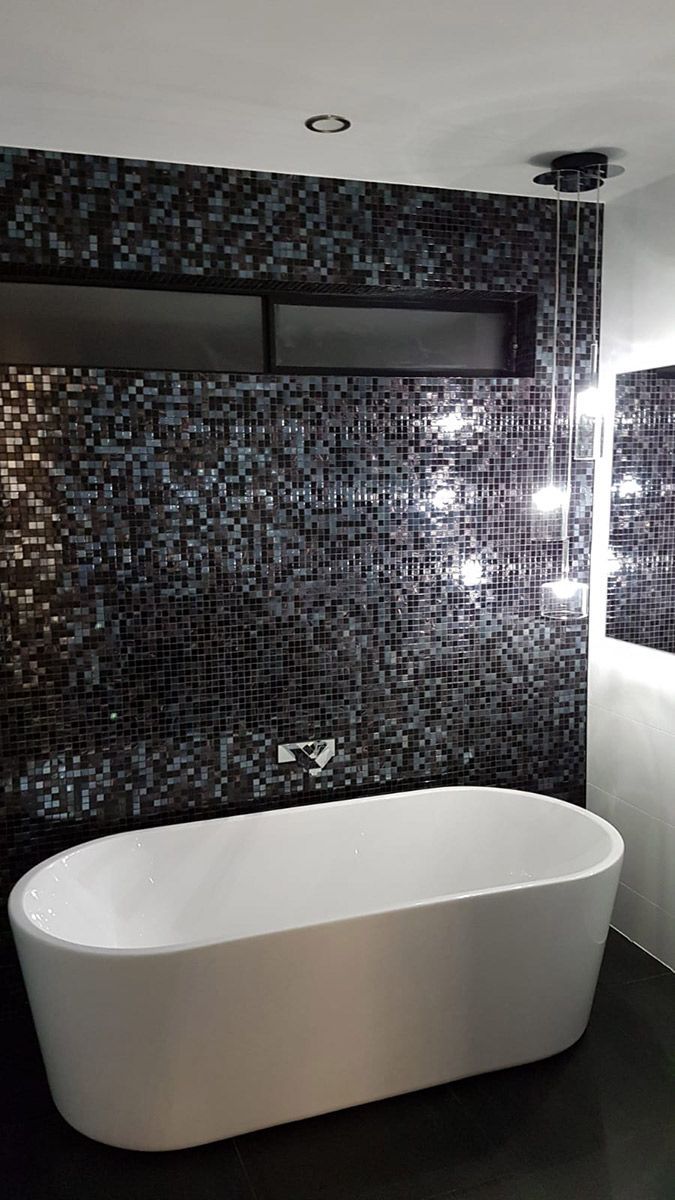 A Bathroom With a Bathtub and a Mirror — Gunter Electrical In Kariong, NSW