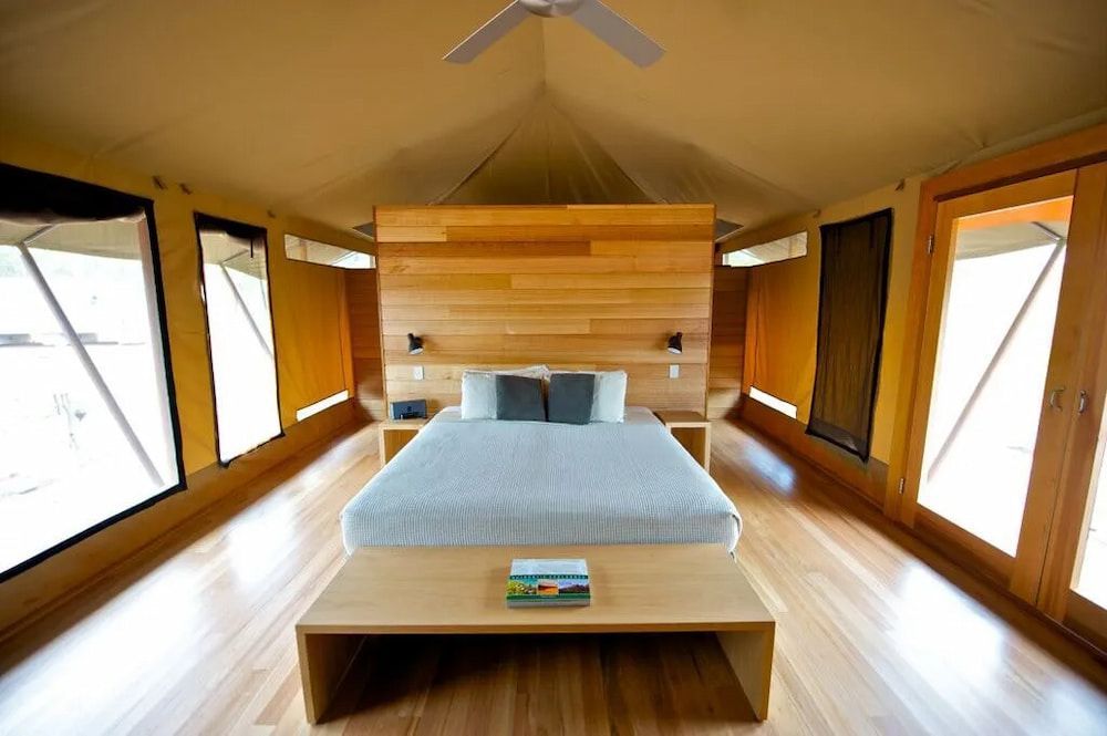 A Bedroom With a Large Bed and a Ceiling Fan — Designer Kitchens in Berrimah, NT