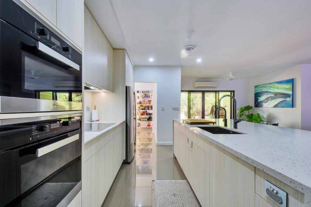 A Kitchen With Stainless Steel Appliances — Designer Kitchens in Berrimah, NT