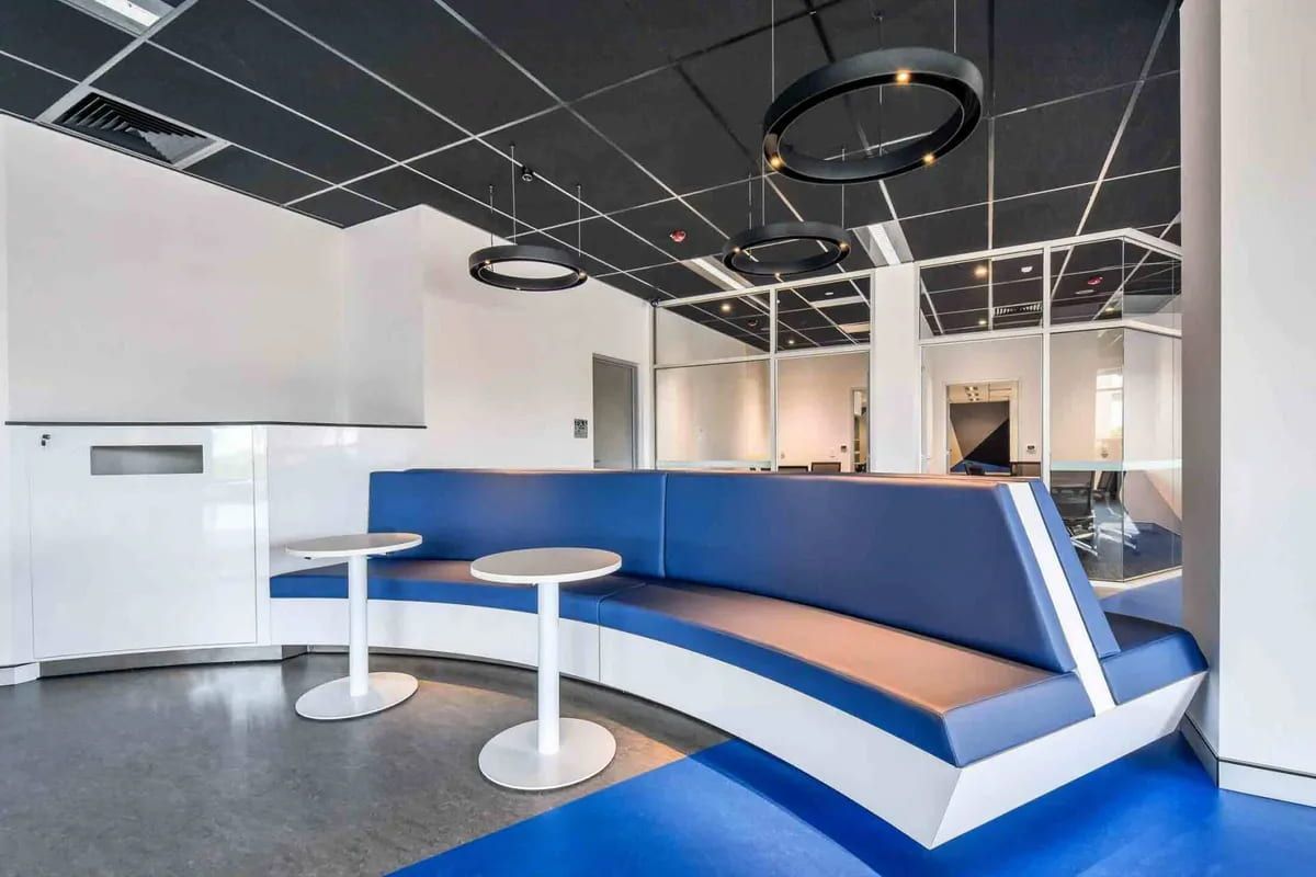 A Room With a Curved Couch and Two Tables — Designer Kitchens in Berrimah, NT