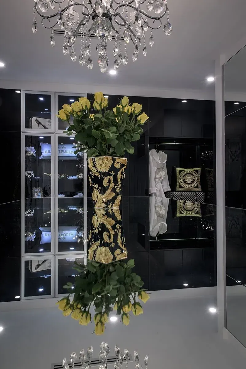 A Room With a Chandelier and a Vase of Flowers — Designer Kitchens in Berrimah, NT