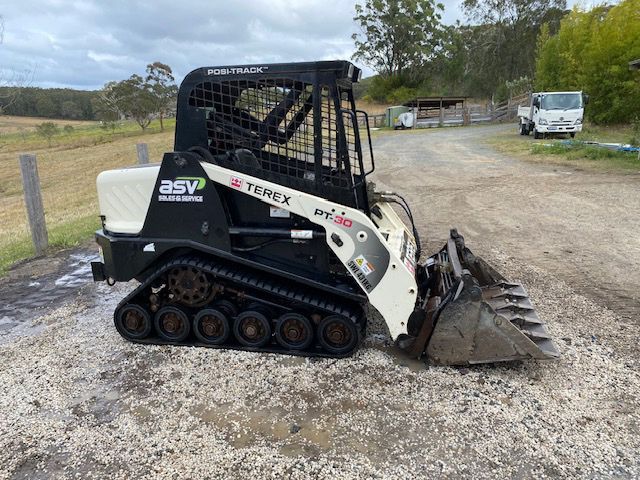 Front Side Left Black And White Positrack — Positrack & Bobcat Hire in Boomerang Beach, NSW