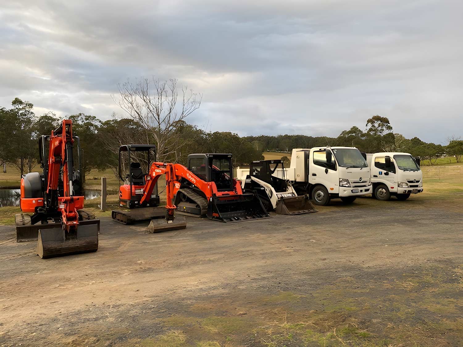 Side Left Orange Excavation, Orange And White Positrack And White Tripper Trucks — Quality Excavation in Boomerang Beach, NSW