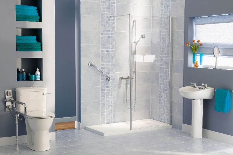 A bathroom with a toilet , sink , and walk in shower.
