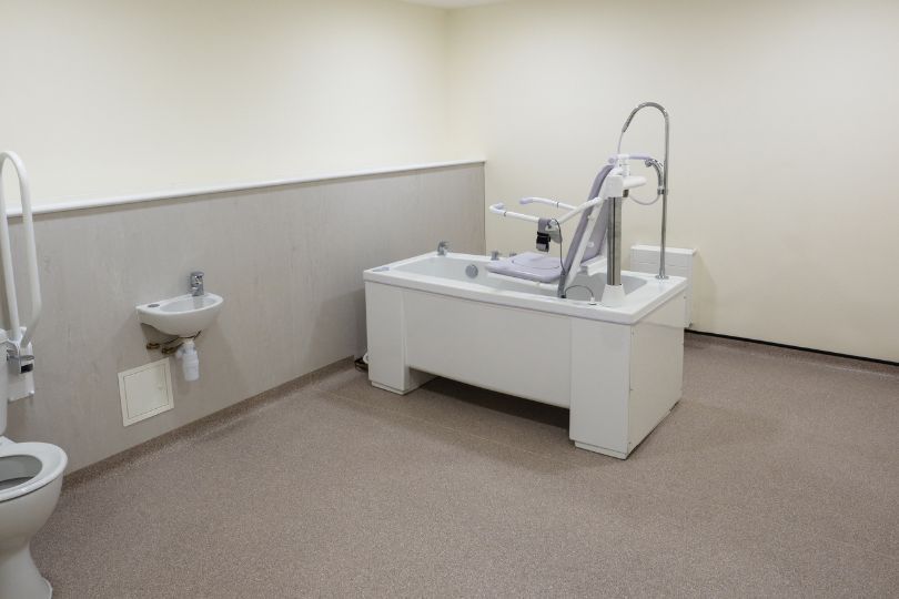 A bathroom with a bathtub , toilet and sink.