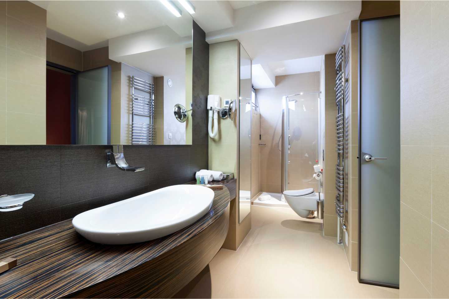 A bathroom with a large sink and a walk in shower