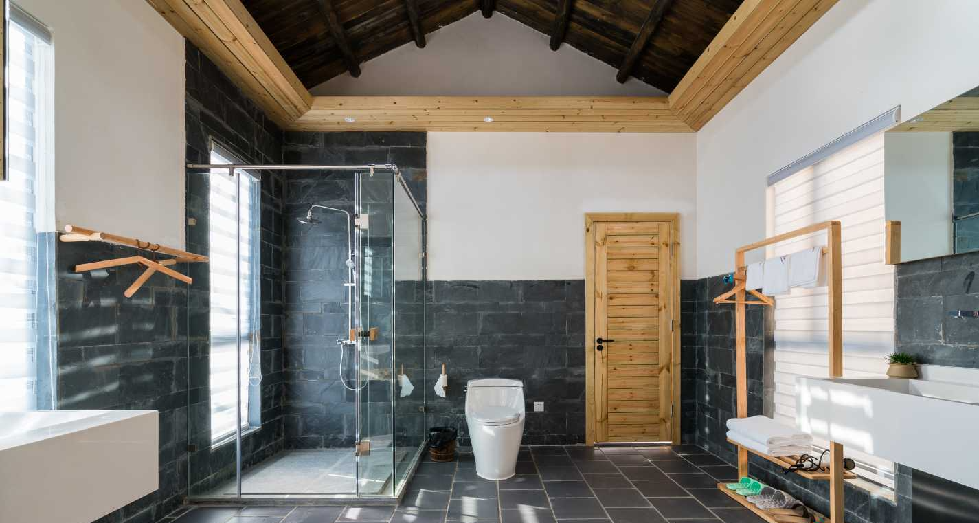A bathroom with a toilet , sink , and shower.