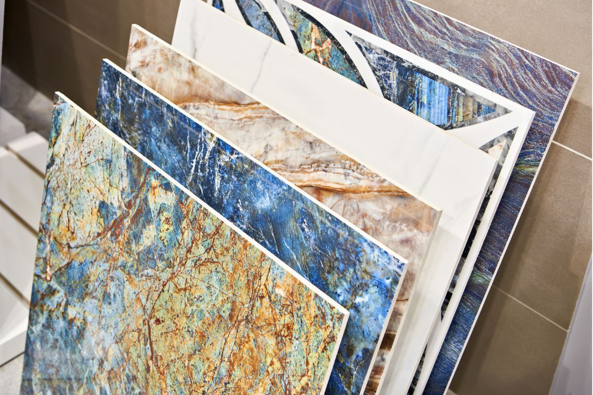 Various colorful ceramic tile samples displayed in a showroom setting.