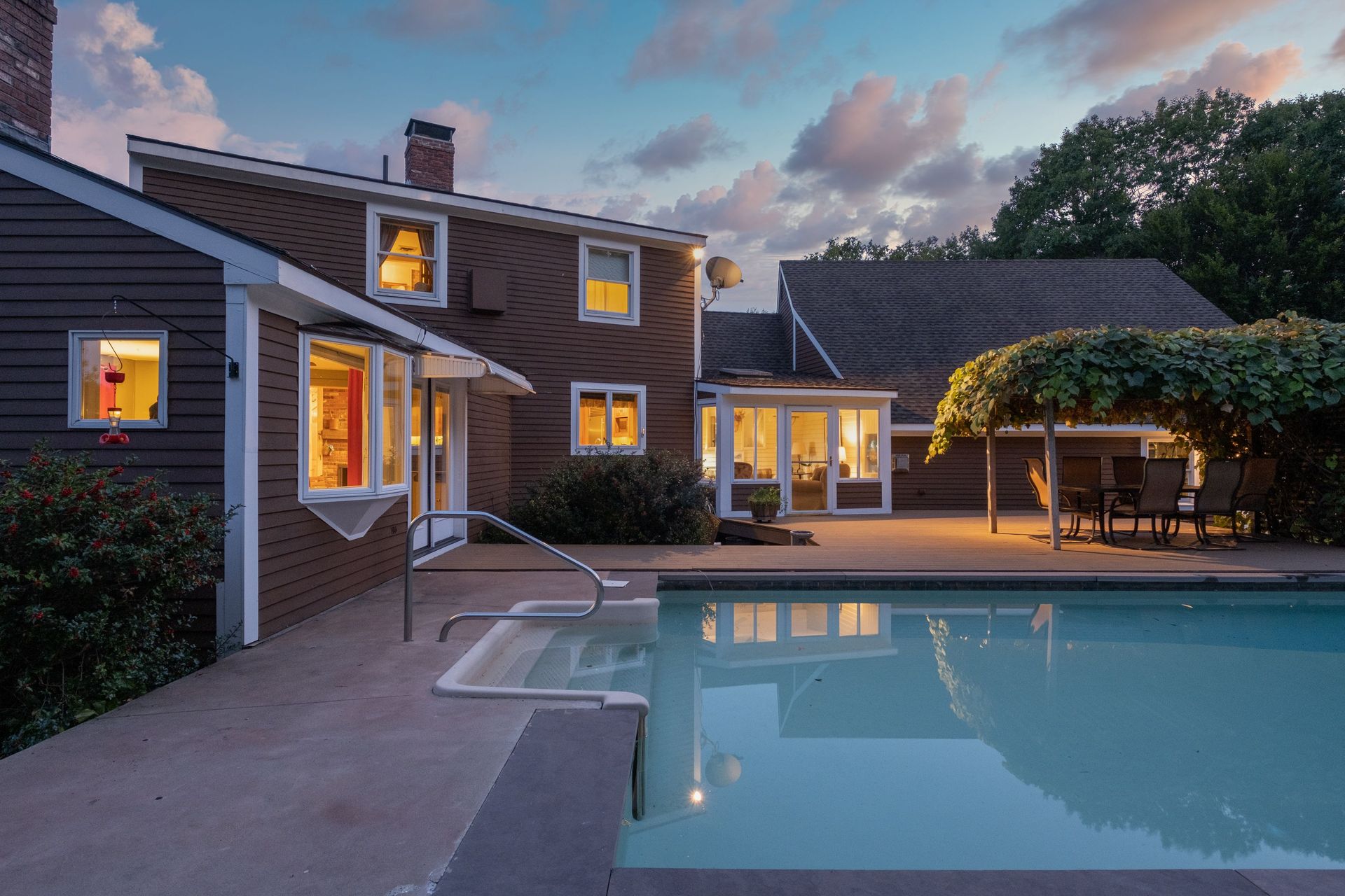 A large house with a swimming pool in front of it