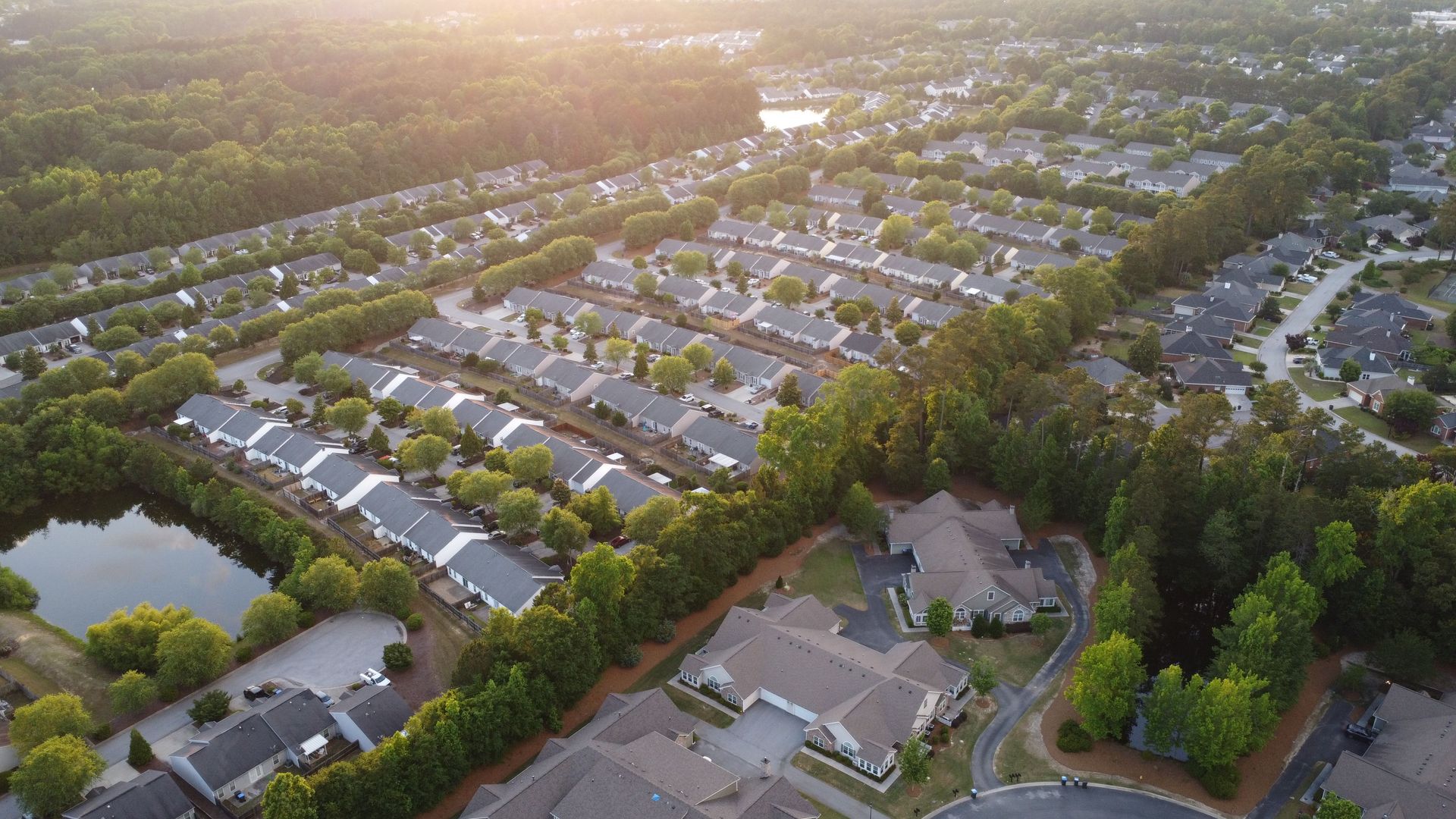 An aerial view of a residential area with lots of houses and trees.