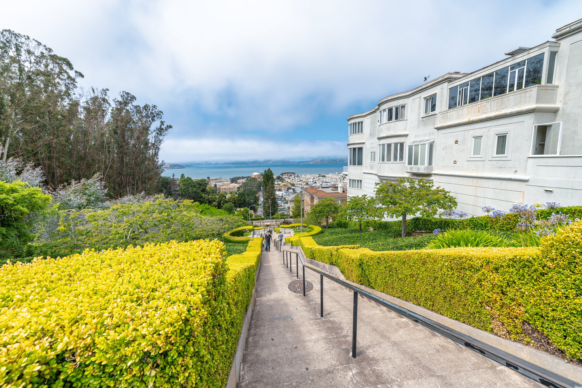 A staircase leading up to a building with a view of the ocean.
