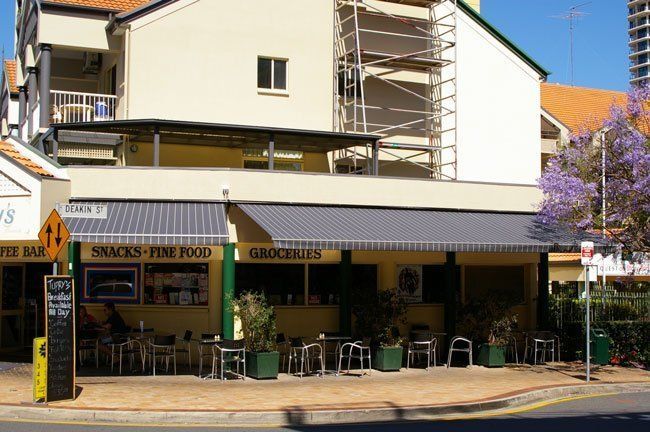 Building With a Sign That Says Snacks Fine Food — Blind Outfitters in Atherton, QLD
