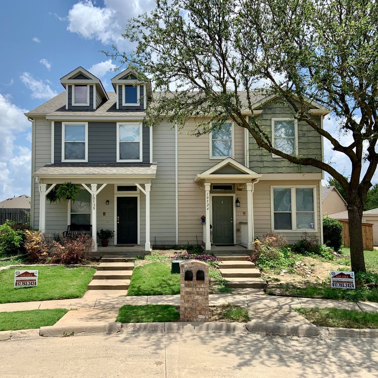 A house with a lot of windows and a tree in front of it.