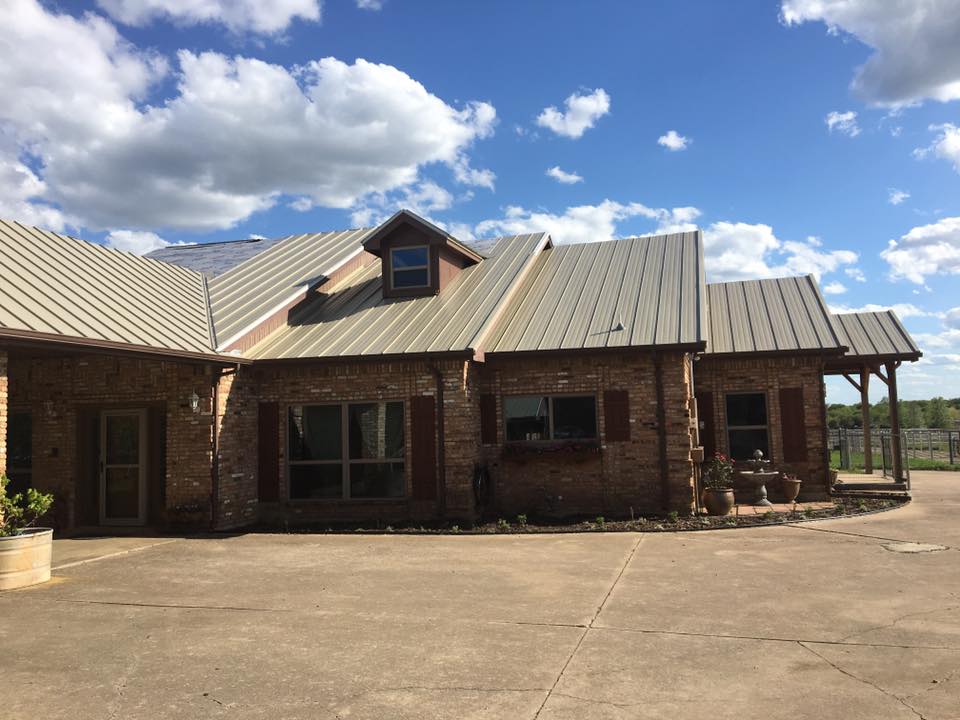 A large brick house with a metal roof