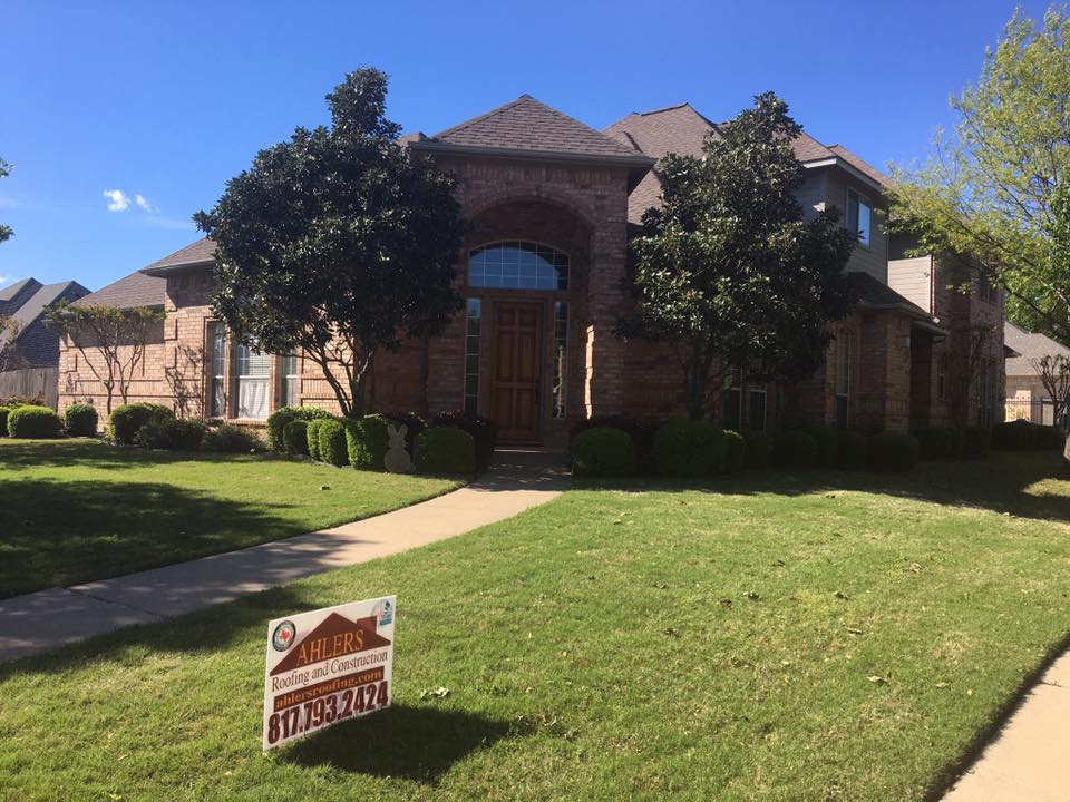 A house with a for sale sign in front of it.
