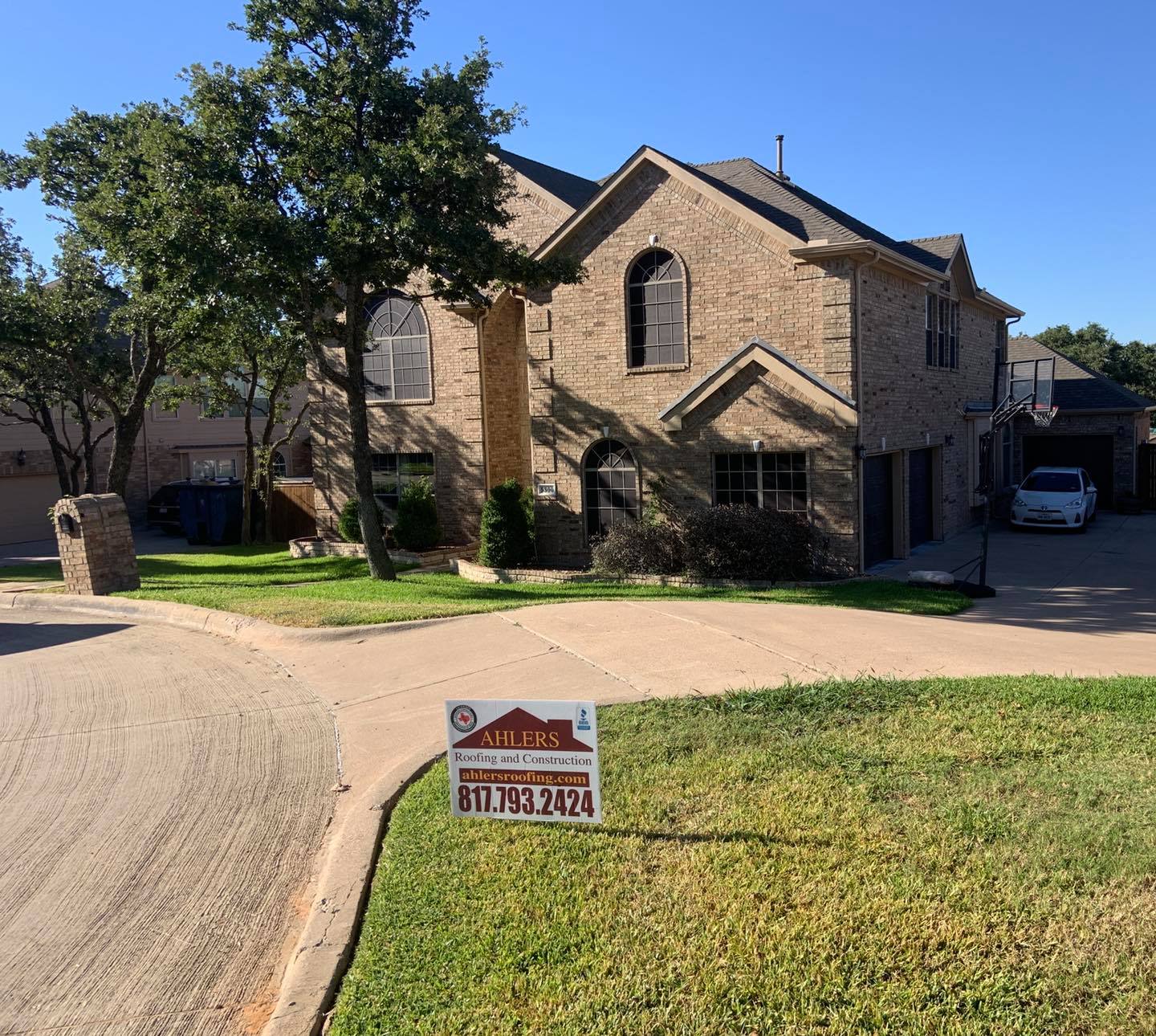A house with a for sale sign in front of it