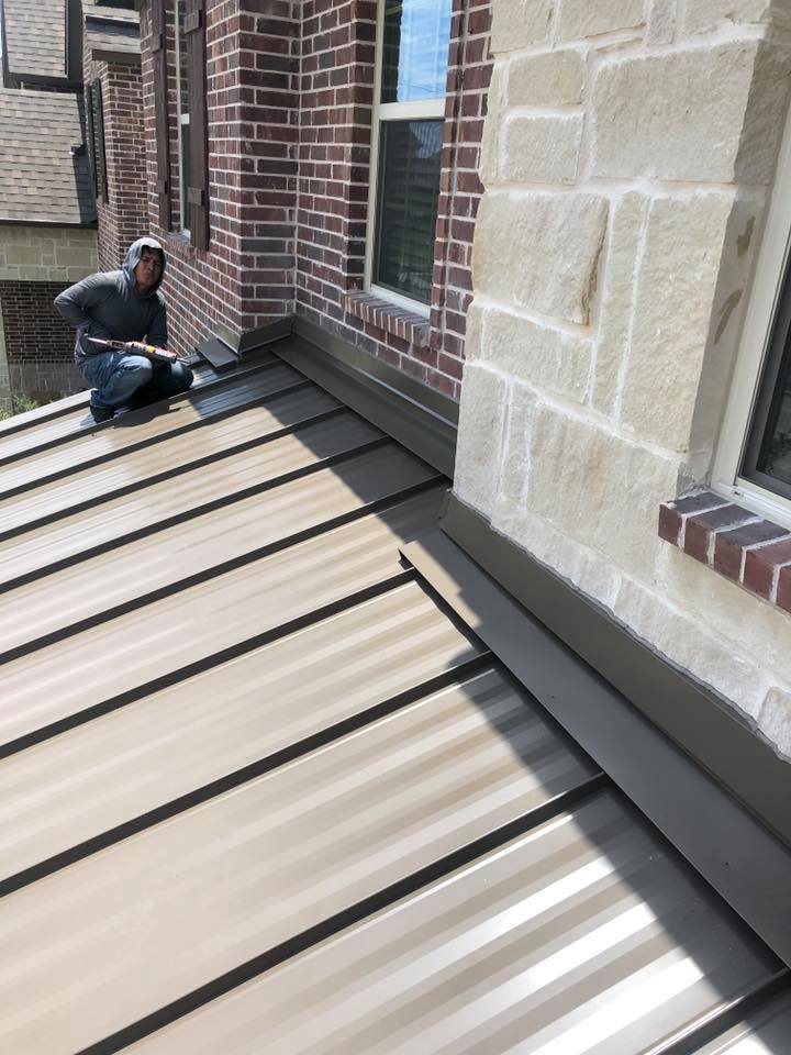 Man working on metal roof