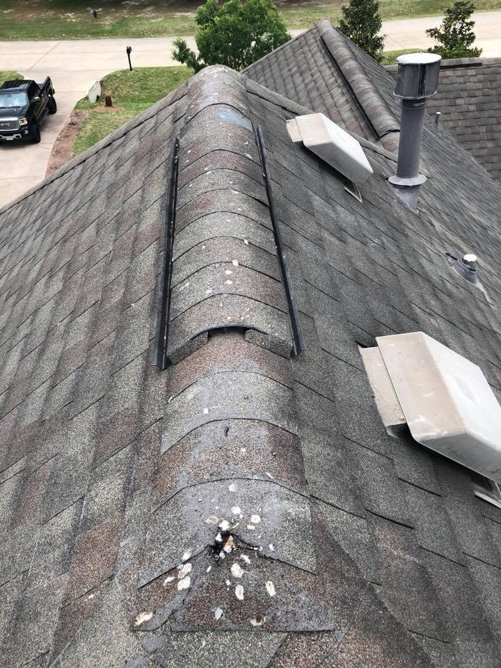 A close up of a roof with a truck parked in the background.
