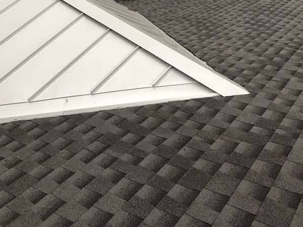 A close up of a roof with a white roof and a black roof.