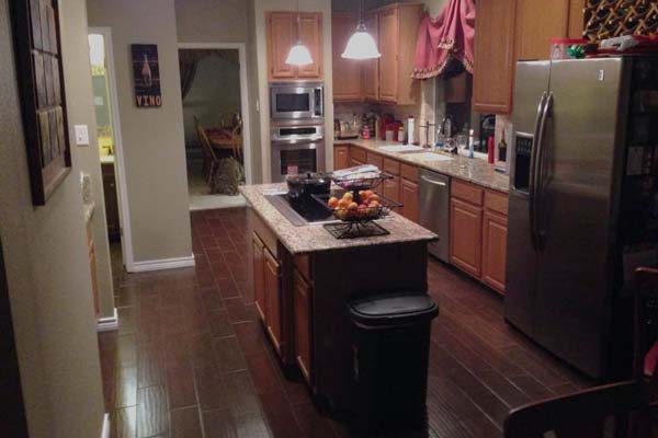 A kitchen with stainless steel appliances and wooden cabinets