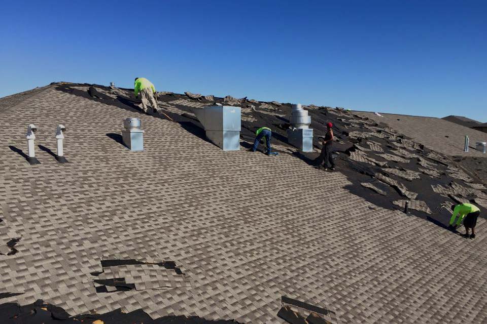 A group of people are working on a roof.