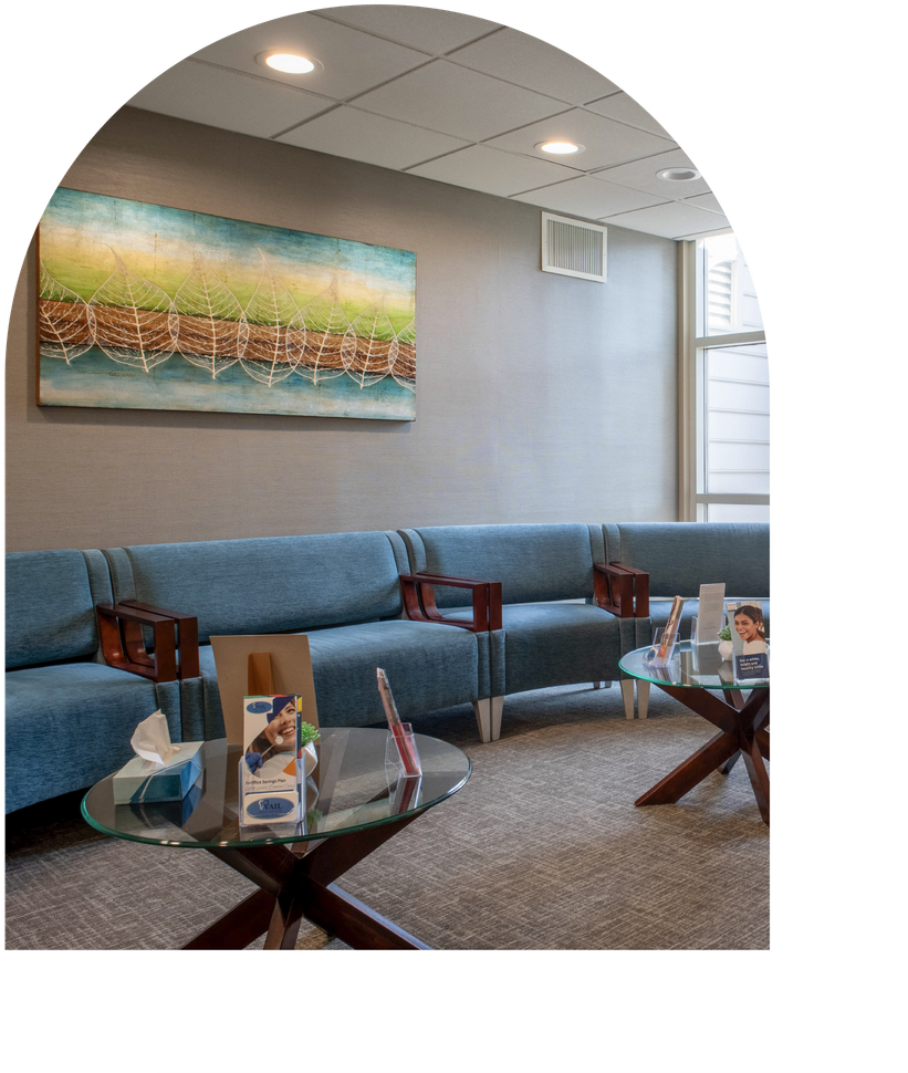 Woman in dentist chair smiles after dental cleaning at Vail Dental Associates in Hunt Valley.