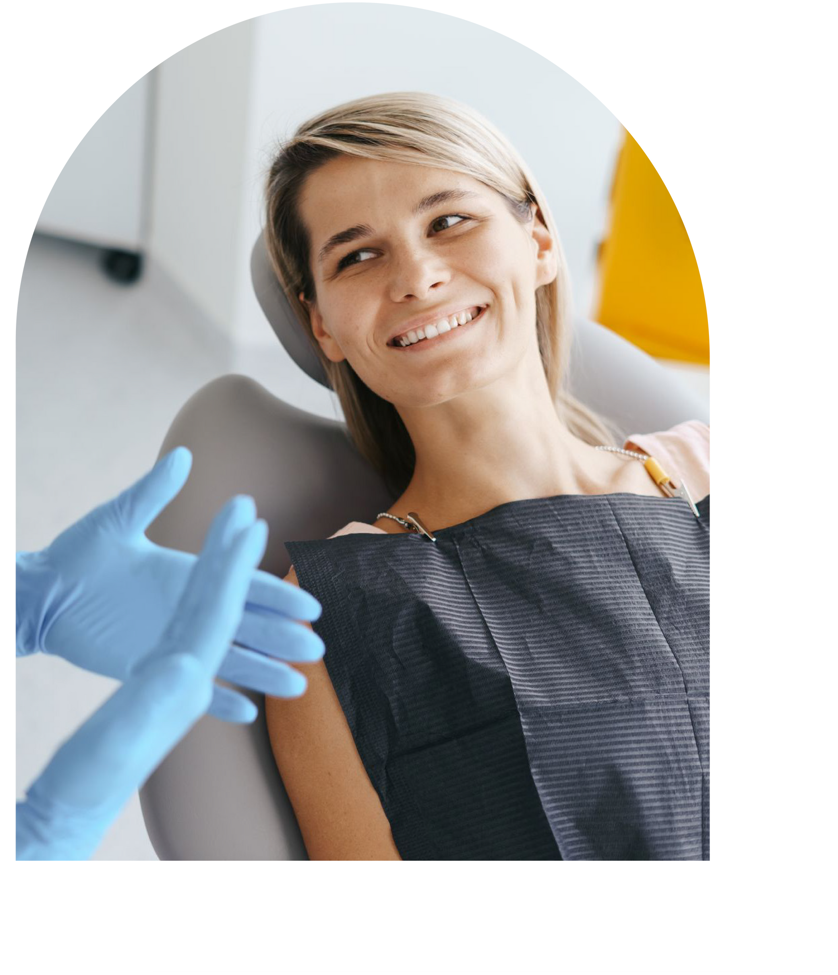 Woman in dentist chair smiles after dental cleaning at Vail Dental Associates in Hunt Valley.