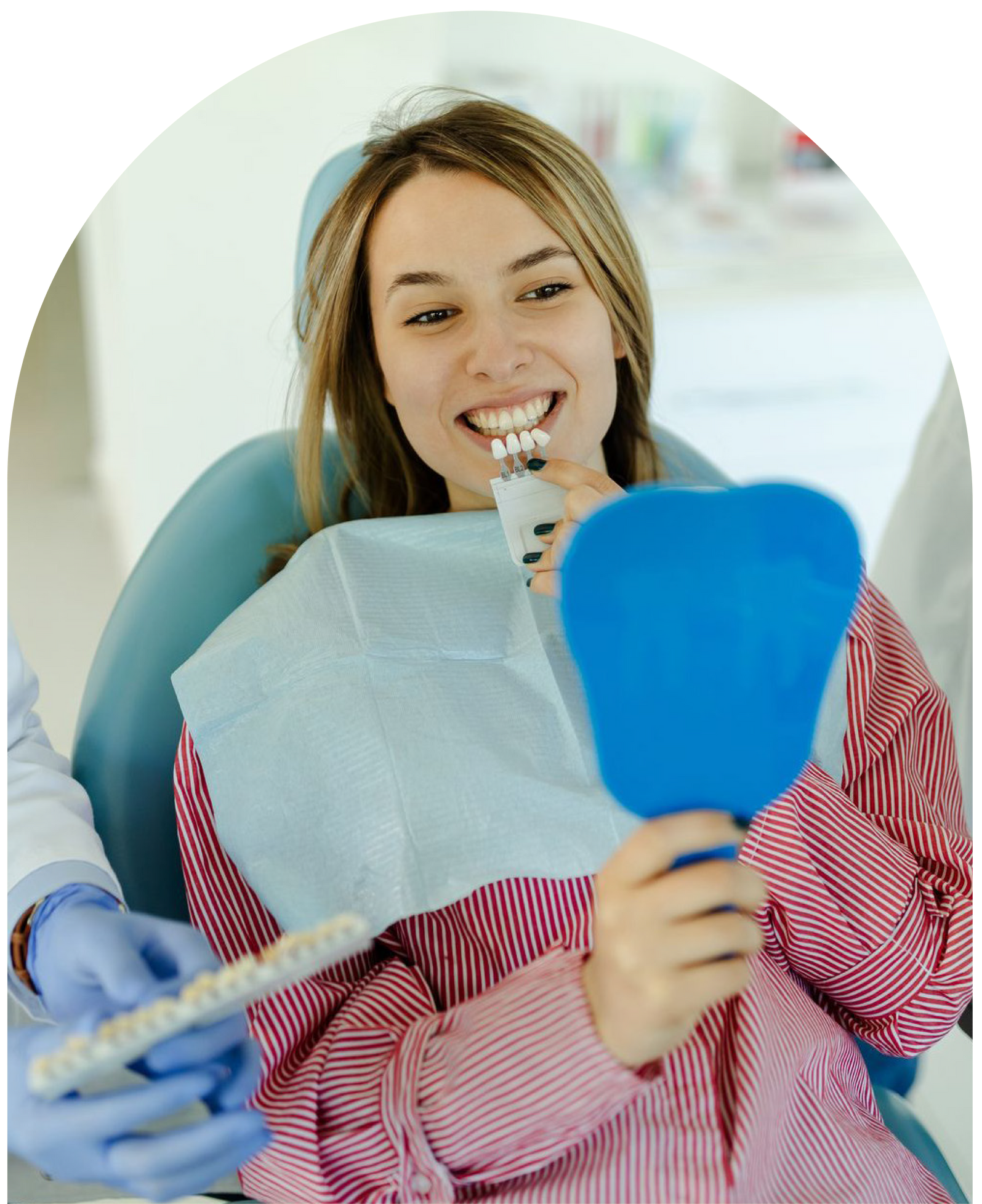 A woman is sitting in a dental chair excitd for veneers at Vail Dental Associates in Hunt Valley, MD, 21030.