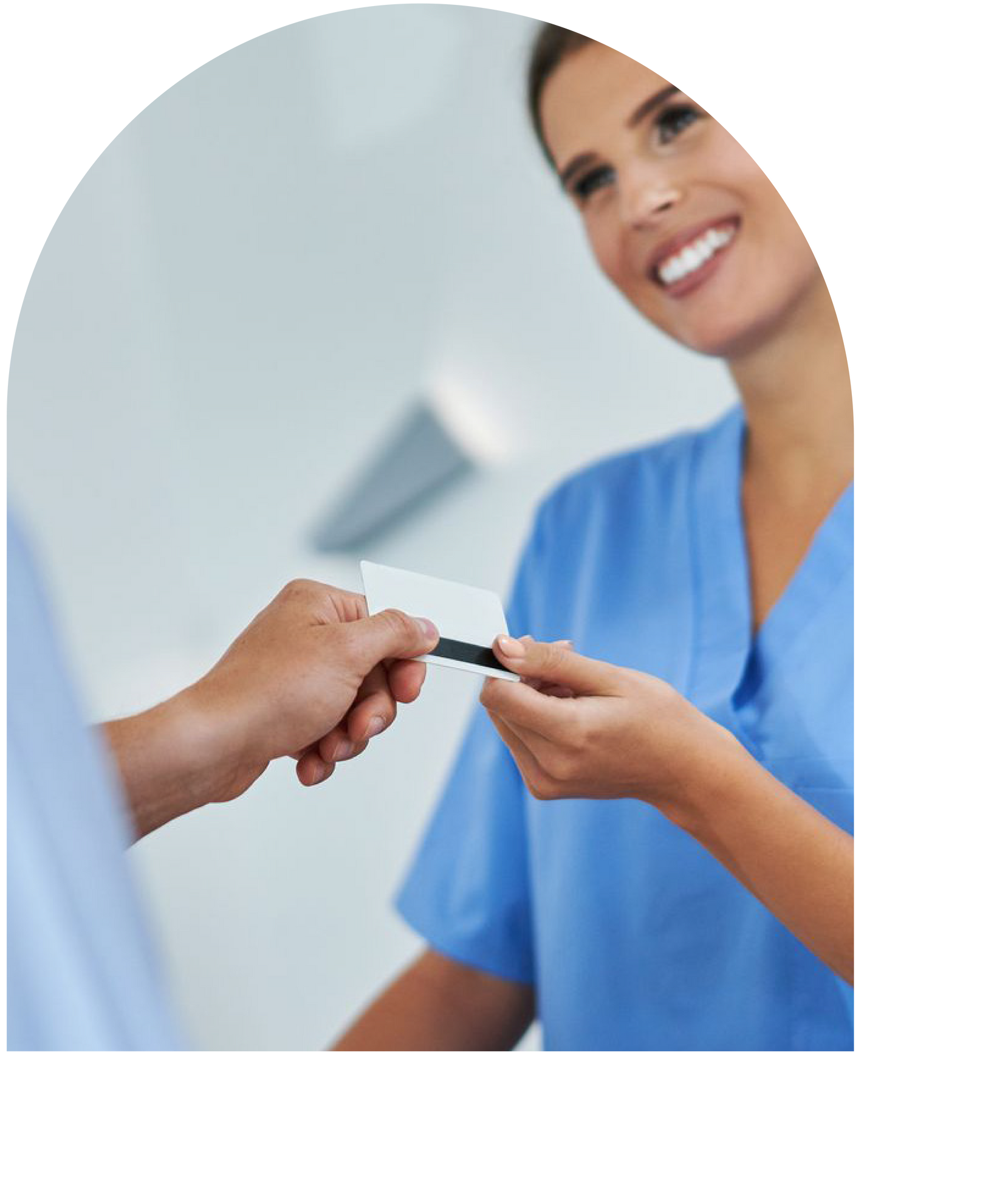 Hygienist in blue scrubs receiving an ID card, smiling in Hunt Valley, Maryland 21030.