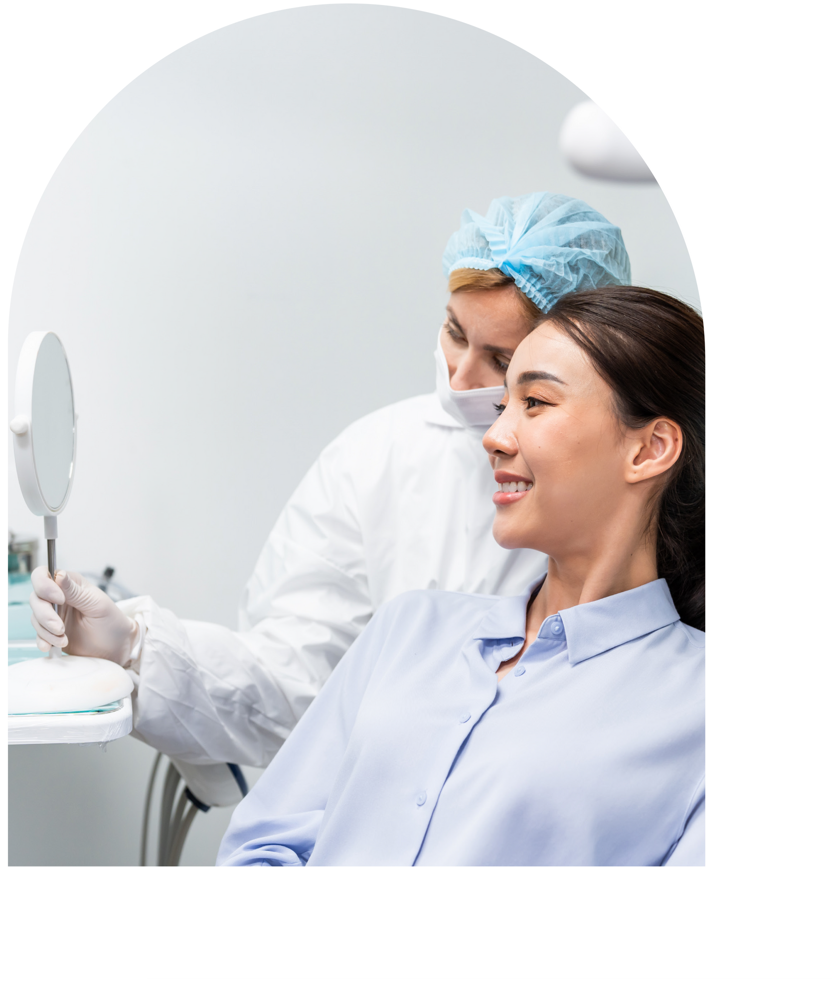 Dentist showing patient a mirror at Vail Dental Associates in Hunt Valley. Patient smiles while looking.