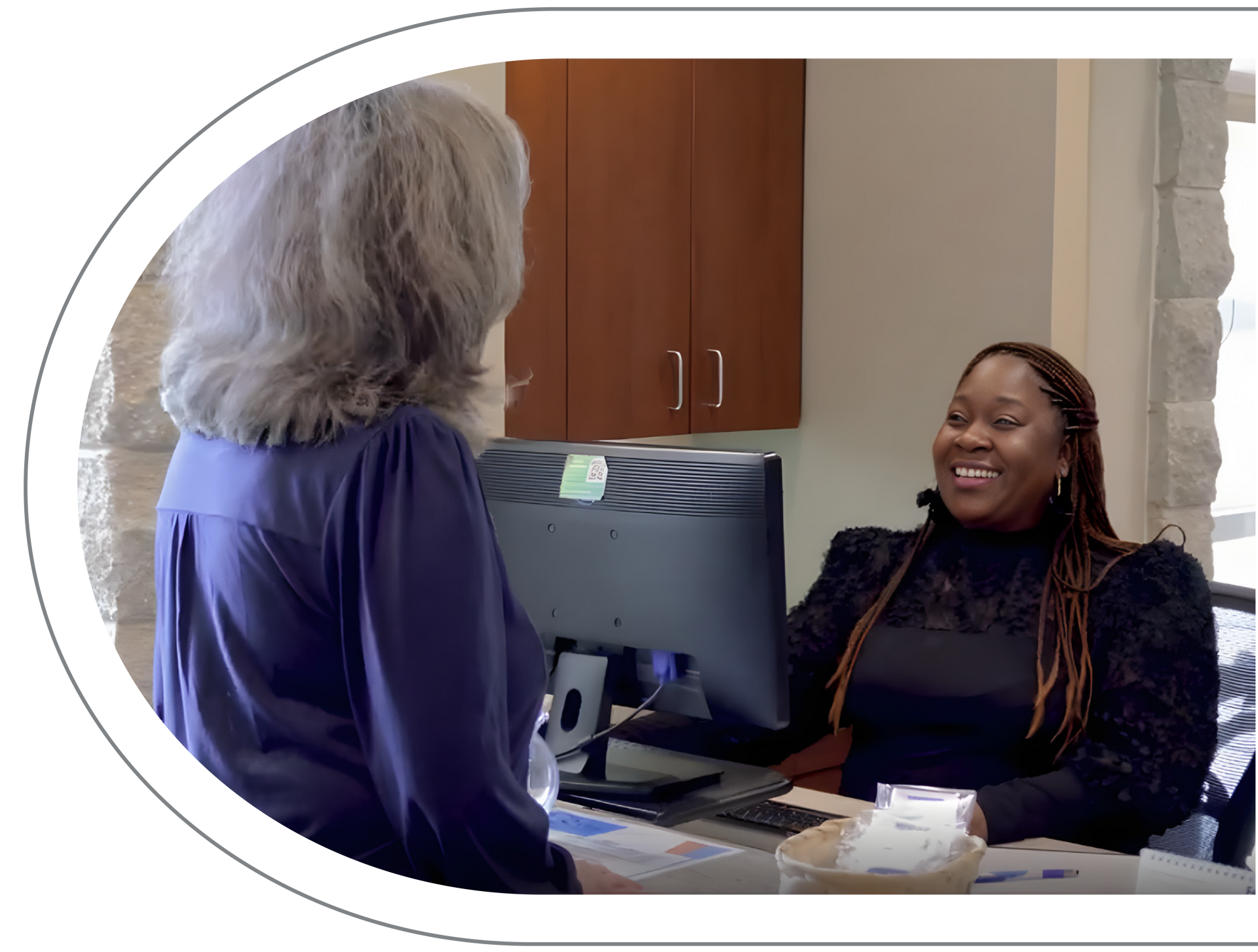Dental professional with patient, reviewing tablet. Both smiling, at Vail Dental Associates in Hunt Valley, MD, 21030..