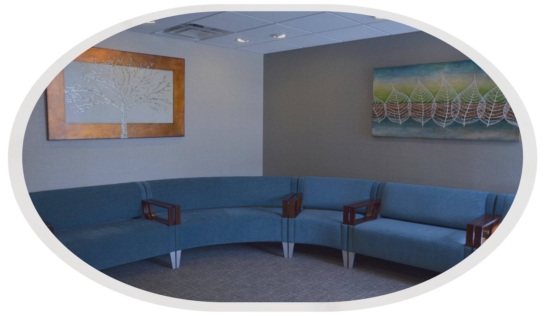 Waiting room at Vail Dental Associates in Hunt Valley, MD, 21030, with blue curved seating, art, and neutral-colored walls.
