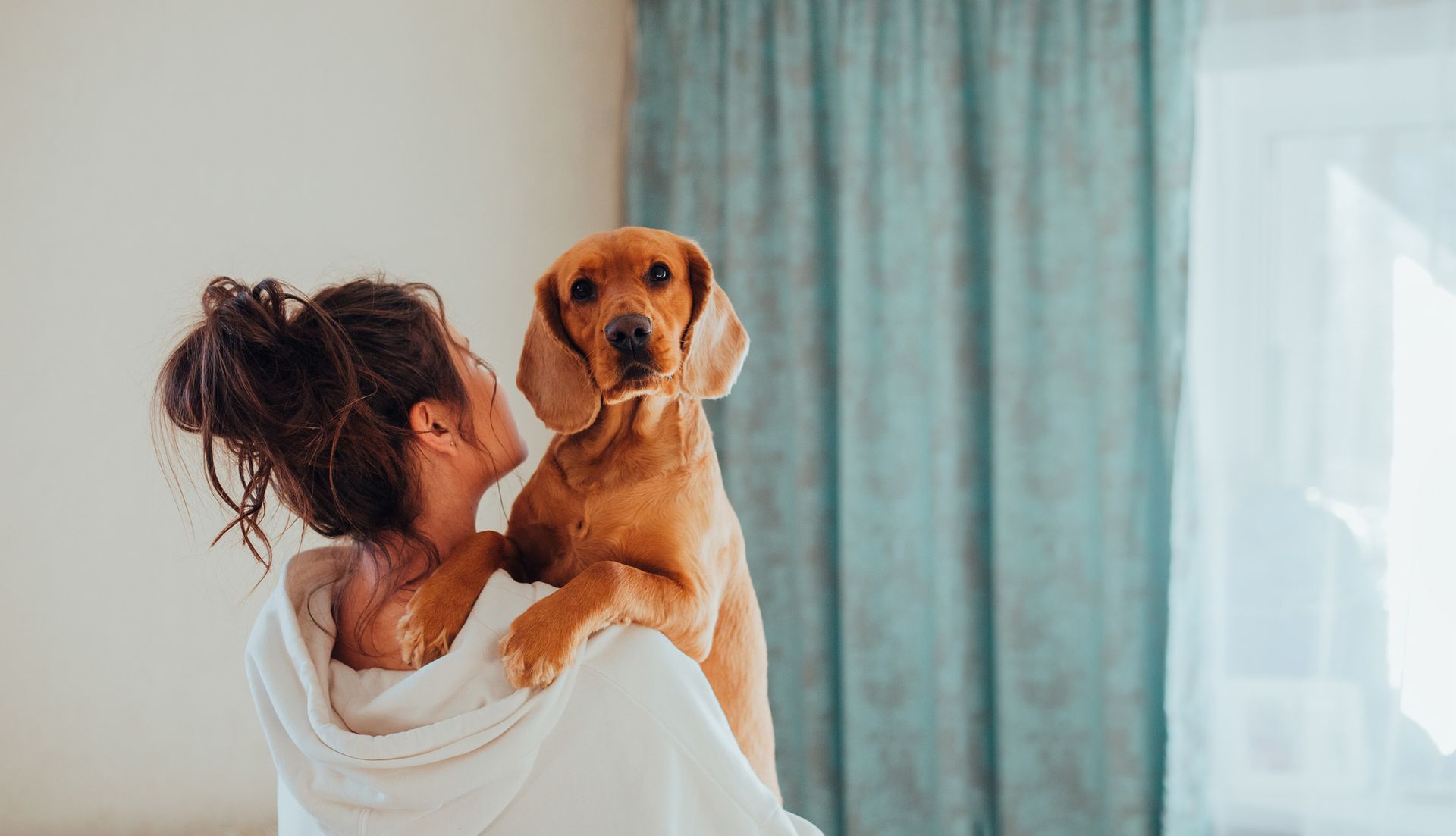A resident holding her dog