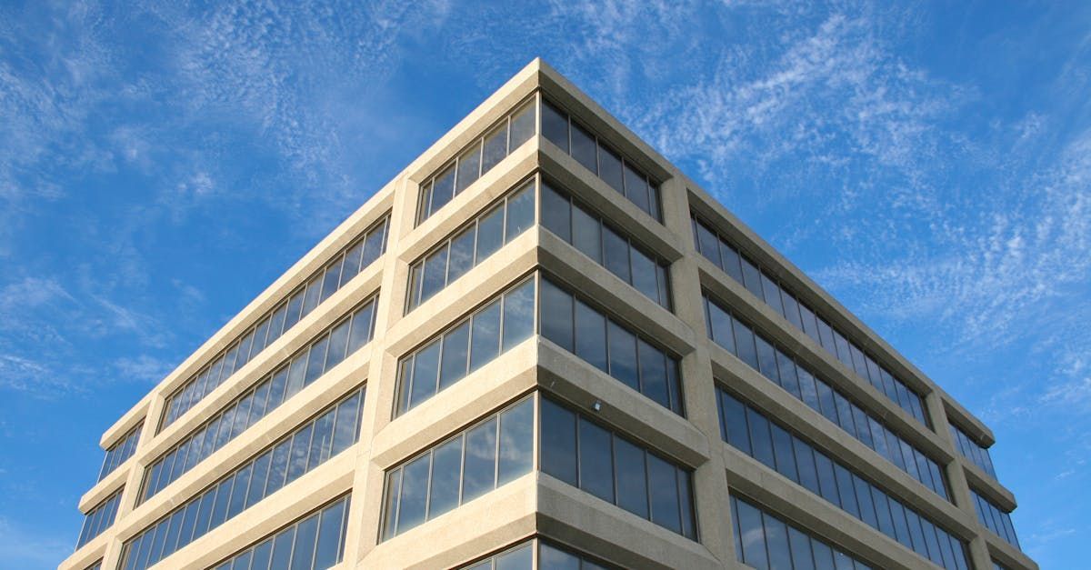 A large building with a lot of windows against a blue sky.