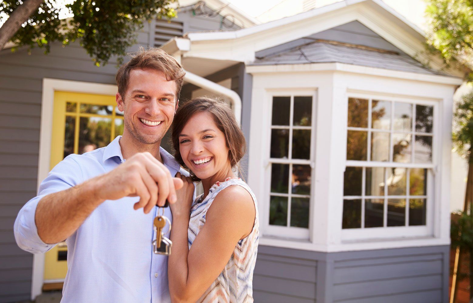 Happy couple holding keys to new home