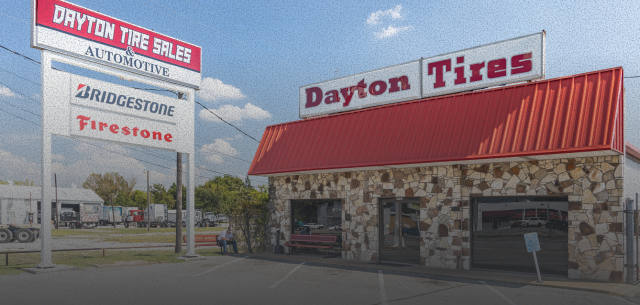 Dayton Tires store with red roof and signs. Includes a Dayton Tire Sales sign and tire brand logos | Dayton Tire & Auto