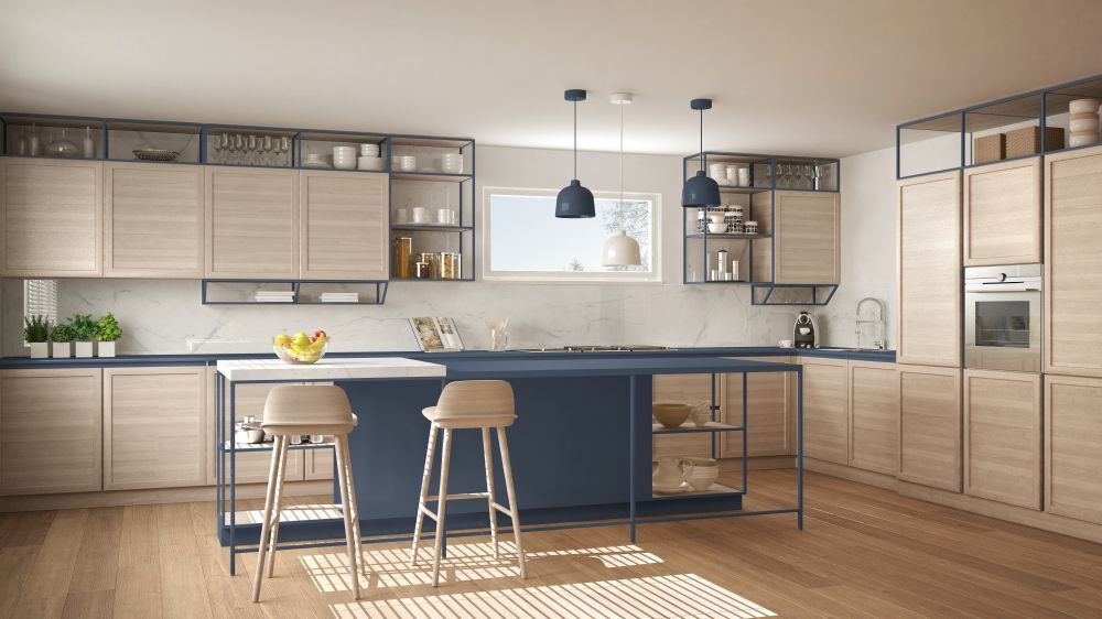 Modern kitchen with light wood cabinets, blue island, and two stools — Carl Whelan Building & Renovations In Wyong, NSW