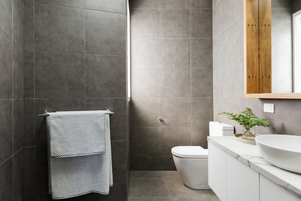Modern Bathroom With Gray Tile Walls, Toilet, Sink — Carl Whelan Building & Renovations In Gosford, NSW