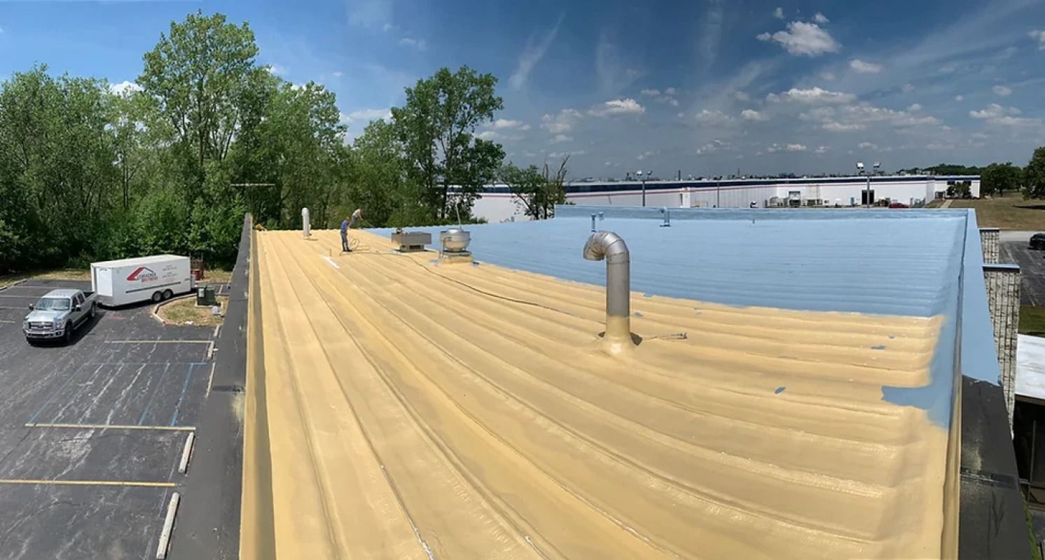 A large building with a blue roof is sitting in a parking lot.