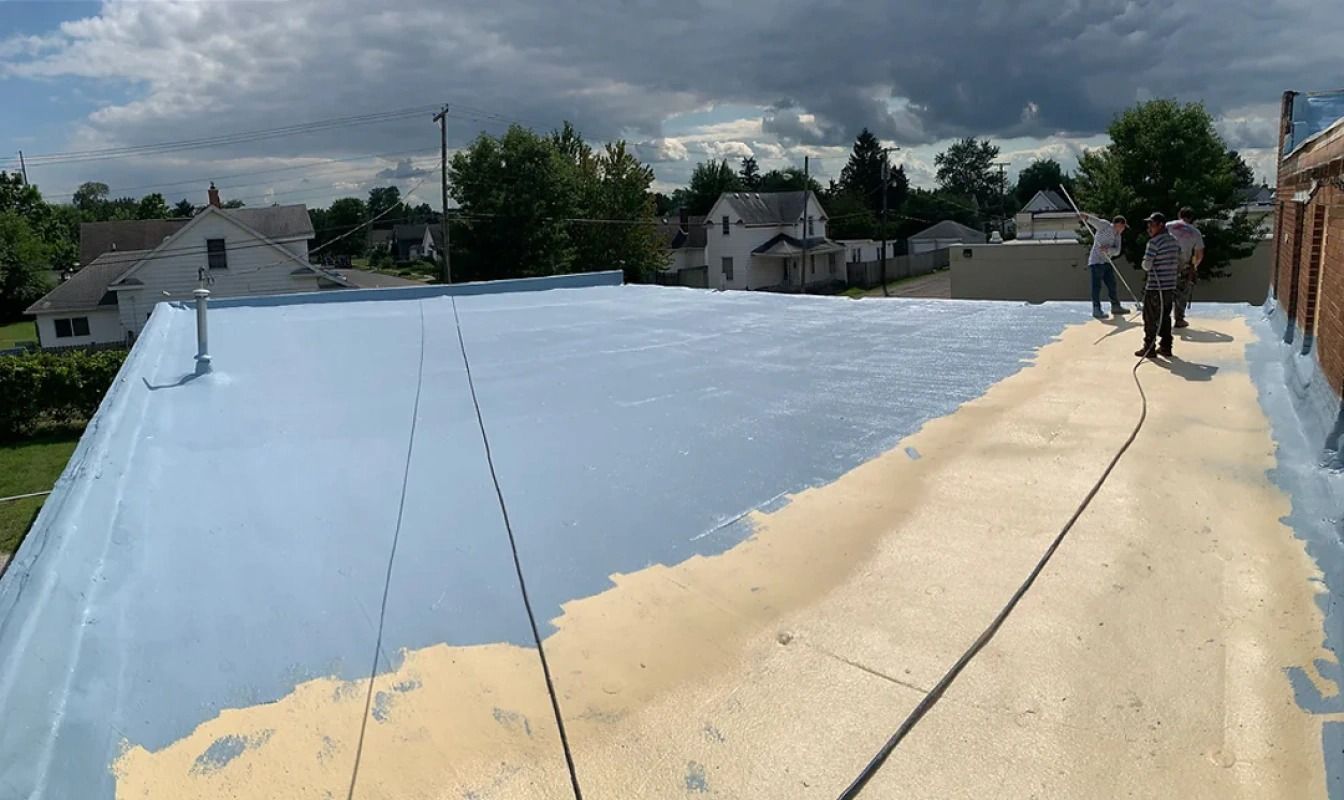A couple of people are standing on top of a roof.
