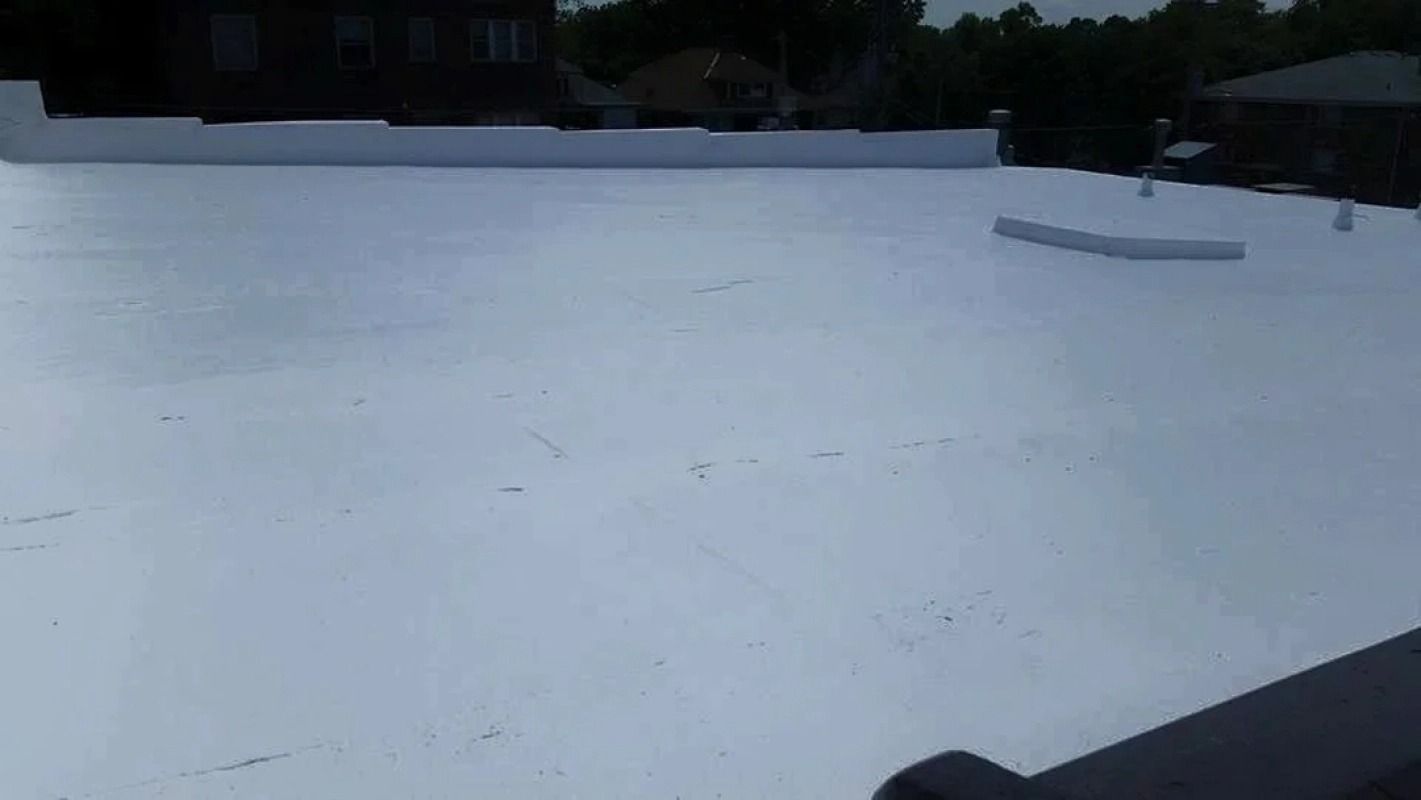 A white roof with a black fence in the background.