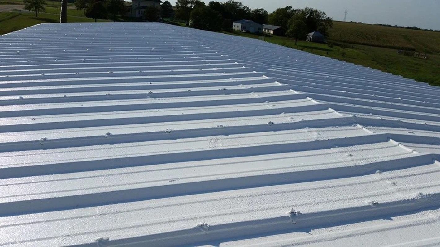 The roof of a building has been painted white.