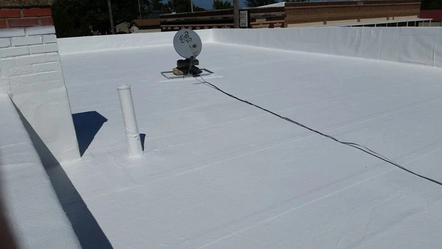 A white roof with a satellite dish on top of it.