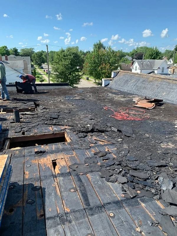 A man is working on the roof of a building.