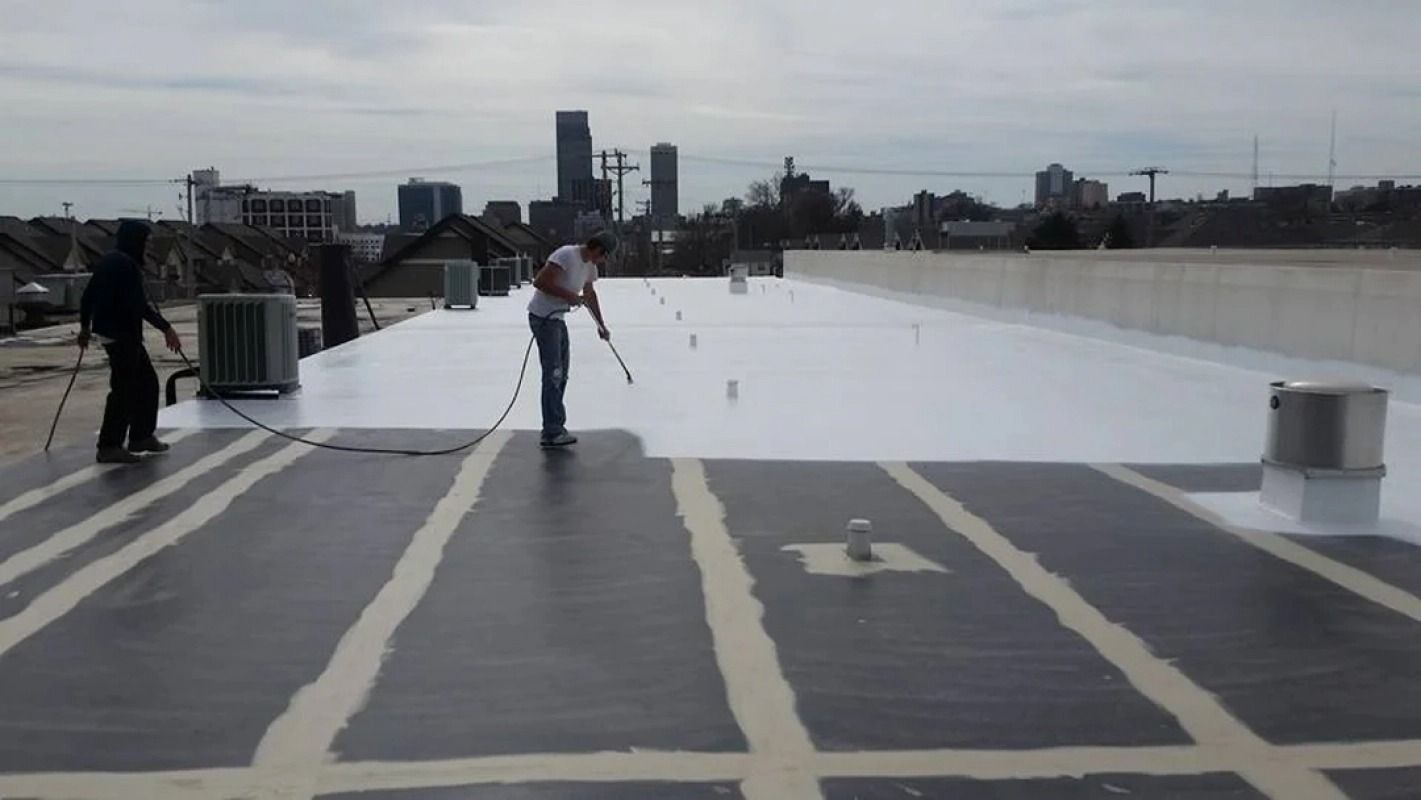 A man is painting a roof with a roller.